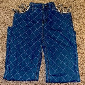 Brand new, never worn Large jeans . Cut out on side with chains .